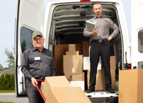 Professional piano removal service handling an upright piano in Hammersmith