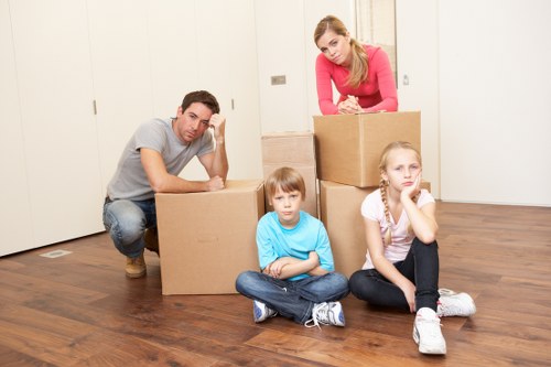 Packed moving boxes and furniture ready for transport in Hammersmith