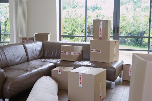 Professional movers carrying furniture through a Hammersmith property