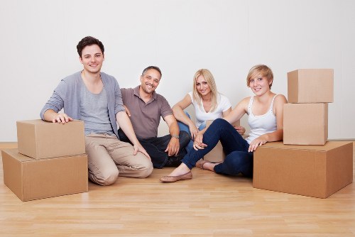 Loading furniture into a removal truck near a West London property