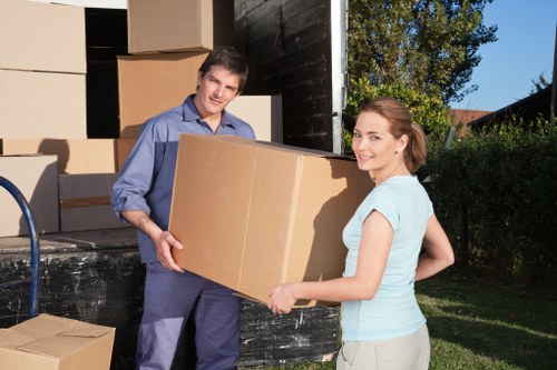 Removal staff wearing PPE while moving items in Hammersmith