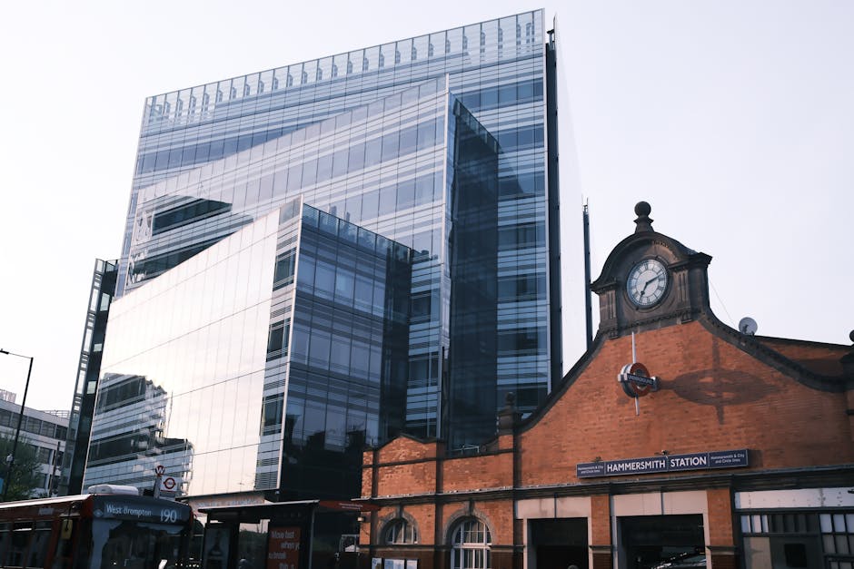 A multi-storey Victorian-style brick building with ornate architectural features, including arched windows, decorative brickwork, and small balconies on the lower floors, situated on King Street in Hammersmith. In front of the building, a street with a parking area is visible, and the entrance features steps leading up to a double door. No moving equipment or personnel are visible in the image, which appears to be taken during daylight with clear skies. This building may be part of a residential or mixed-use property, and it is situated in an urban area suitable for house removals or home relocation services, as represented on the website removalvanhammersmith.co.uk.